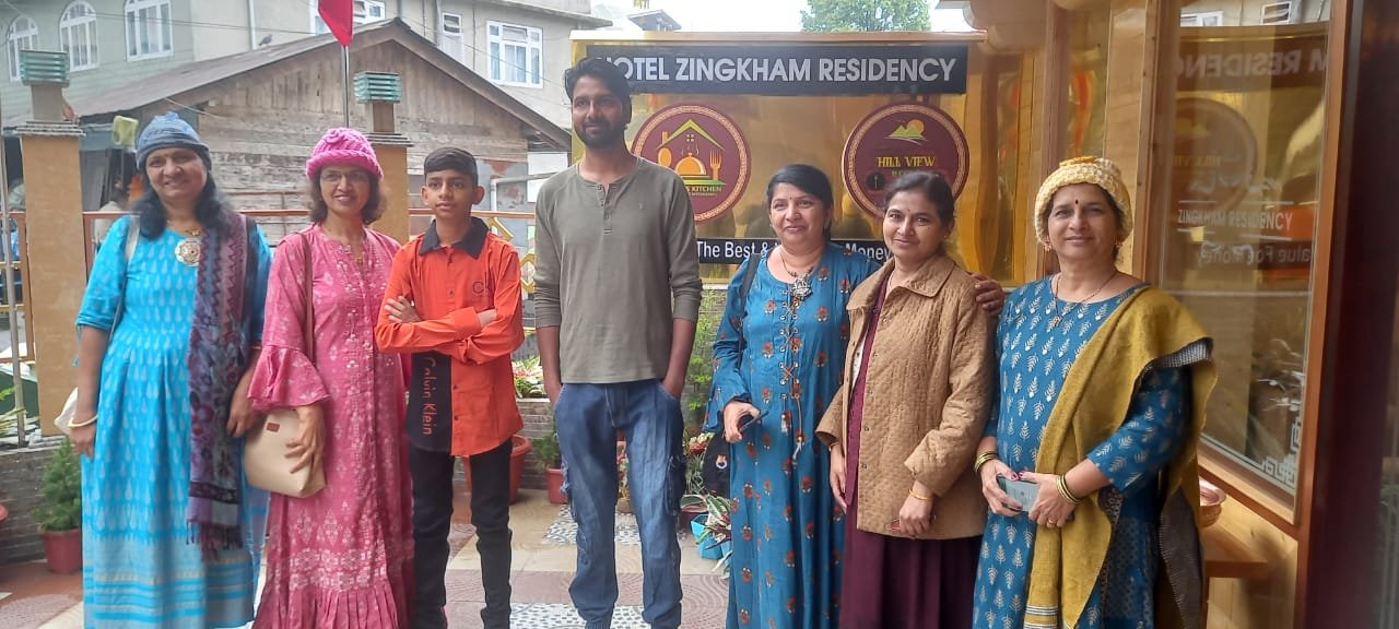Family at their hill-station hotel during a Sikkim package