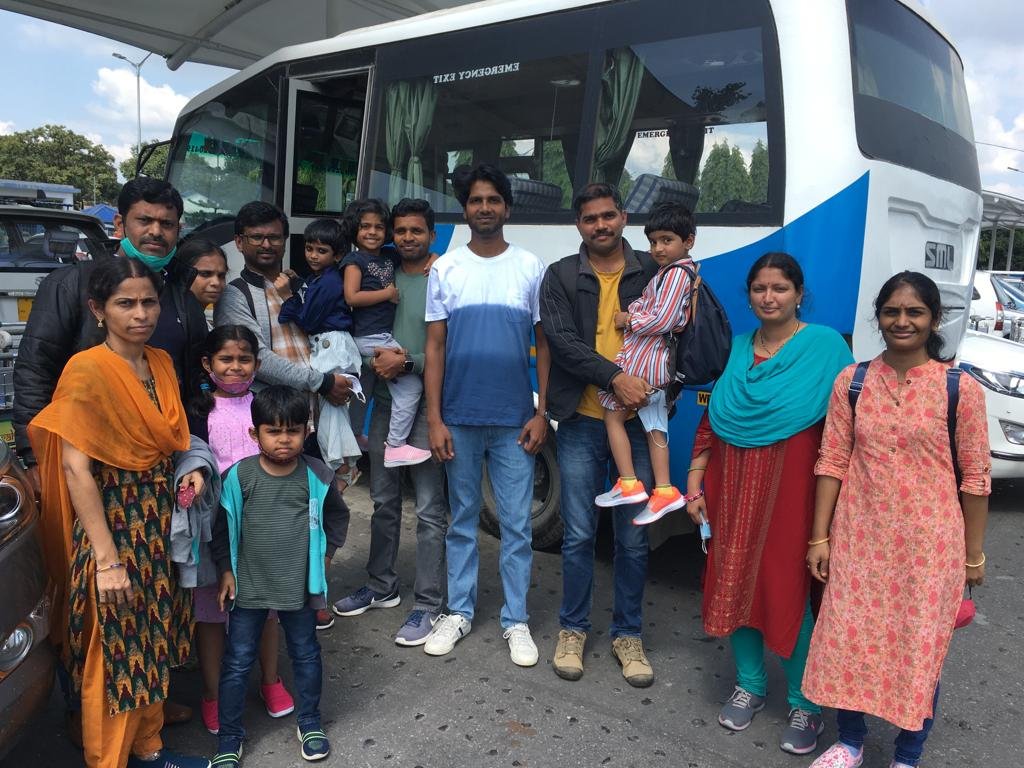Three-generation family with their tour coach before departure