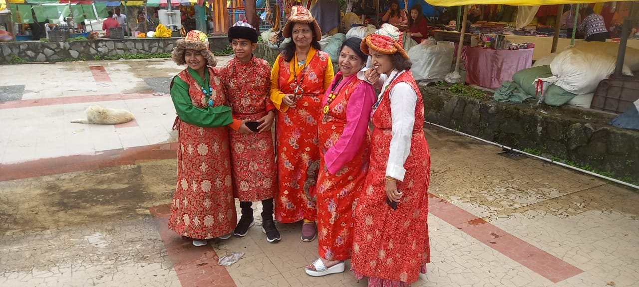 Travellers in traditional dress at a Sikkim market square