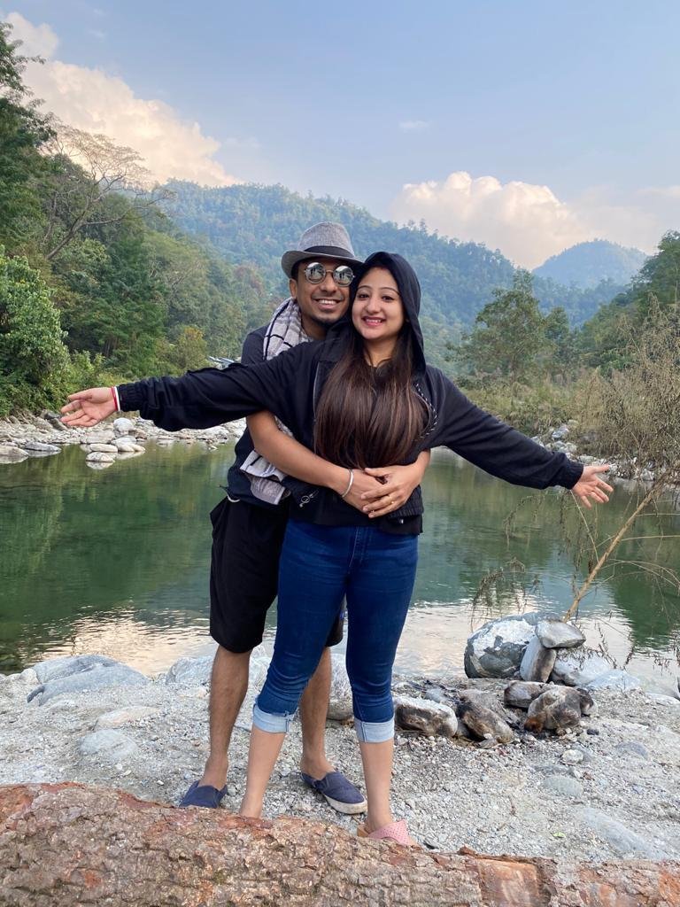 Honeymoon couple embracing beside the Teesta river