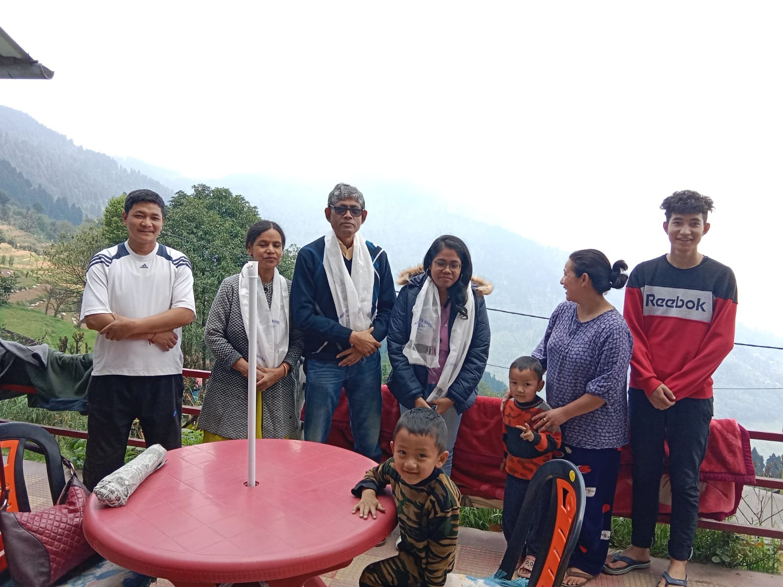 Family at a hill-top viewpoint above the Kanchenjunga range