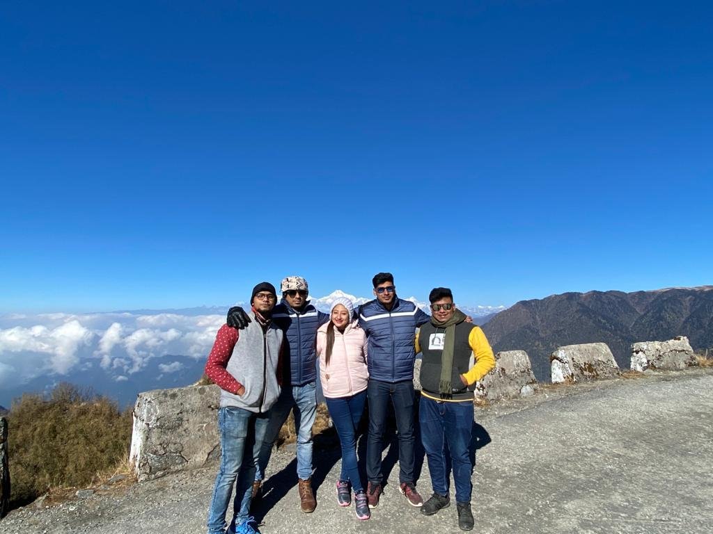 Friends cheering above the clouds at the Tiger Hill sunrise point