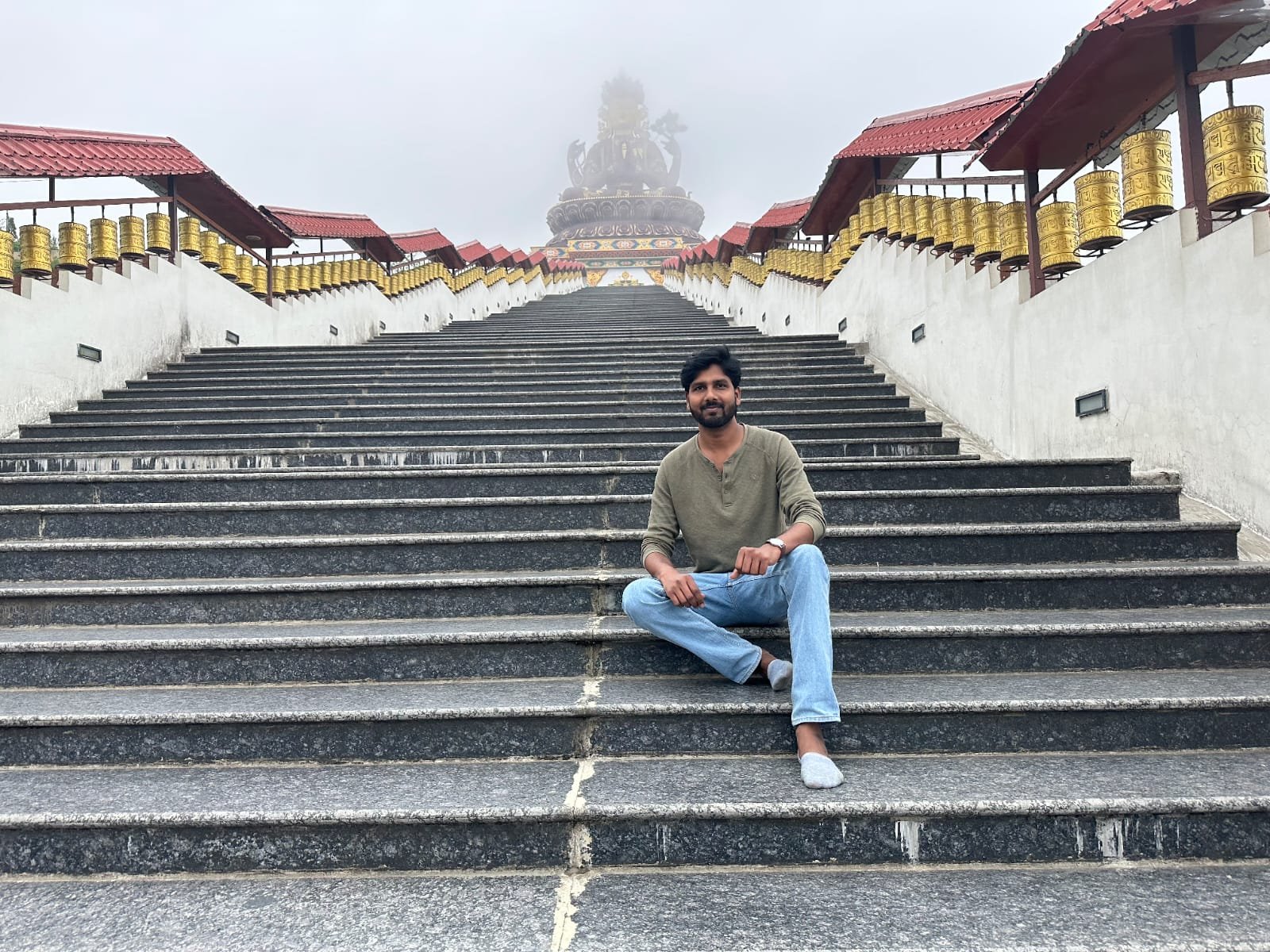 Traveller on the prayer-flag steps at Ravangla Buddha Park